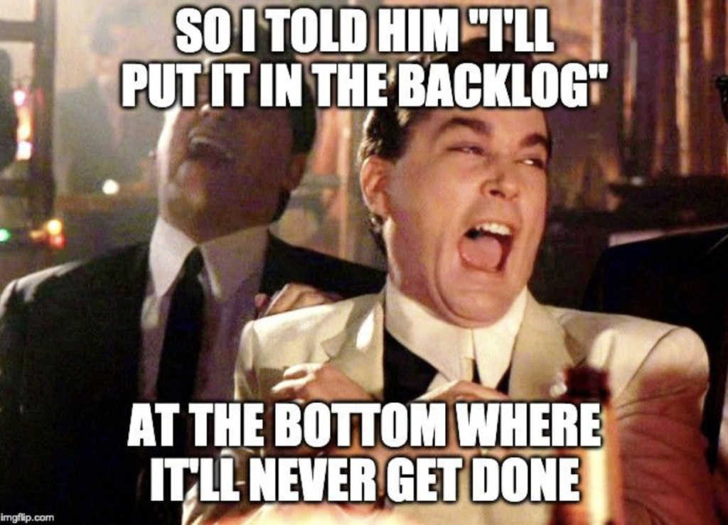 project management meme: goodfellas image laughing at putting a feature in the backlog